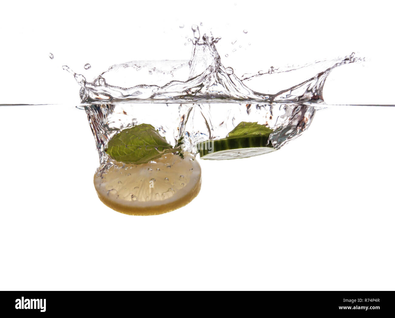 Cucumber slice and mint sinking underwater Stock Photo