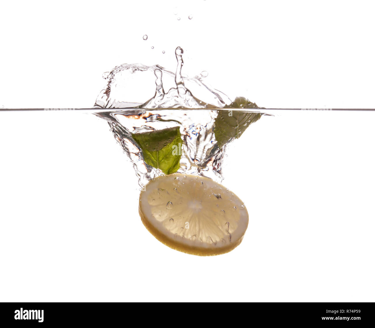 Lemon slice and mint sinking underwater Stock Photo