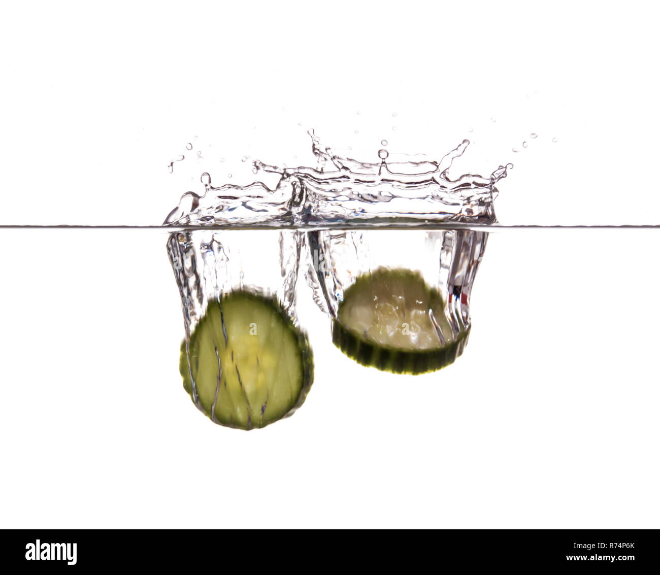 Slice of cucumber sinking underwater Stock Photo - Alamy