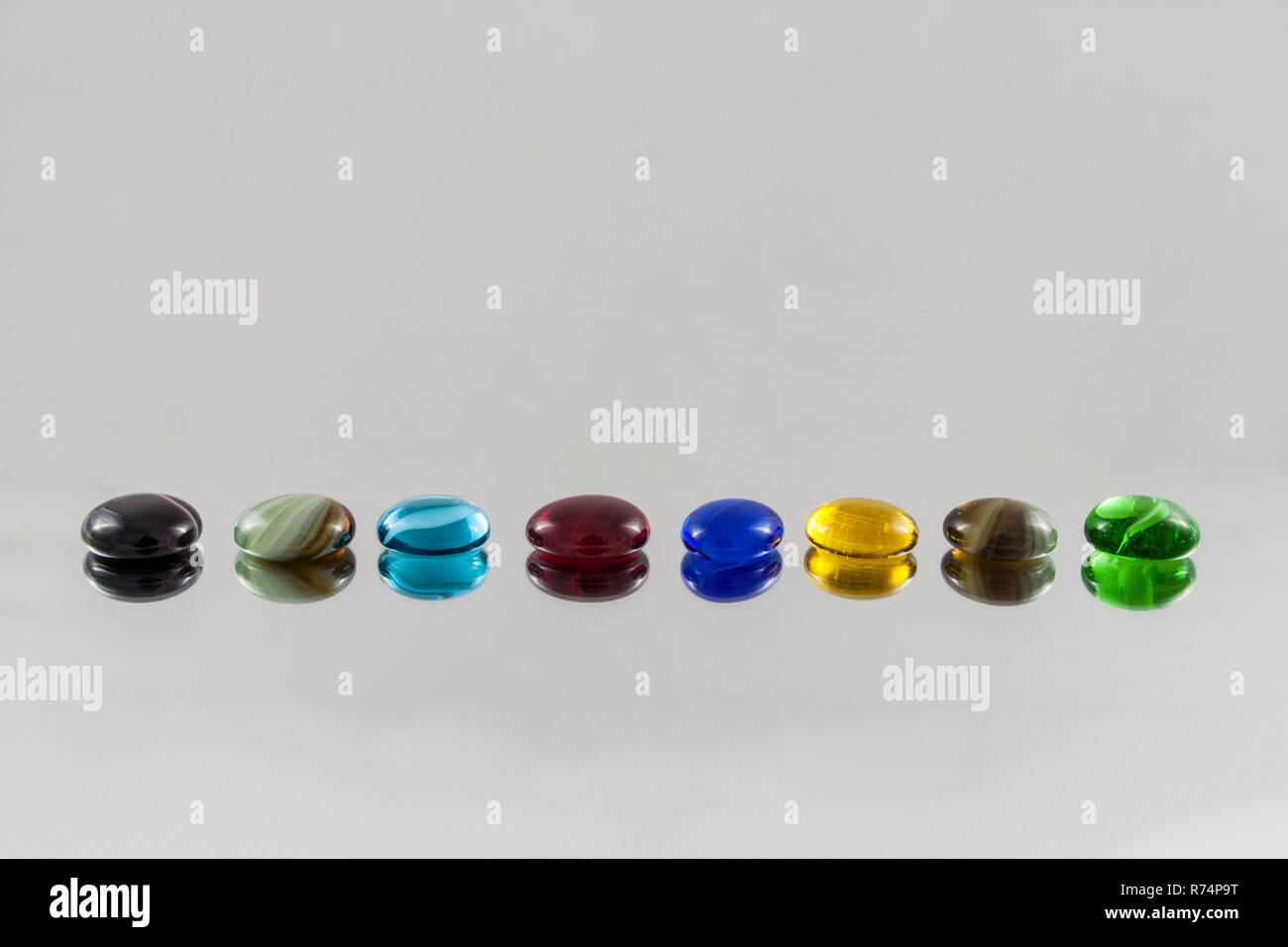 Arranged glass gems with blurred reflections Stock Photo