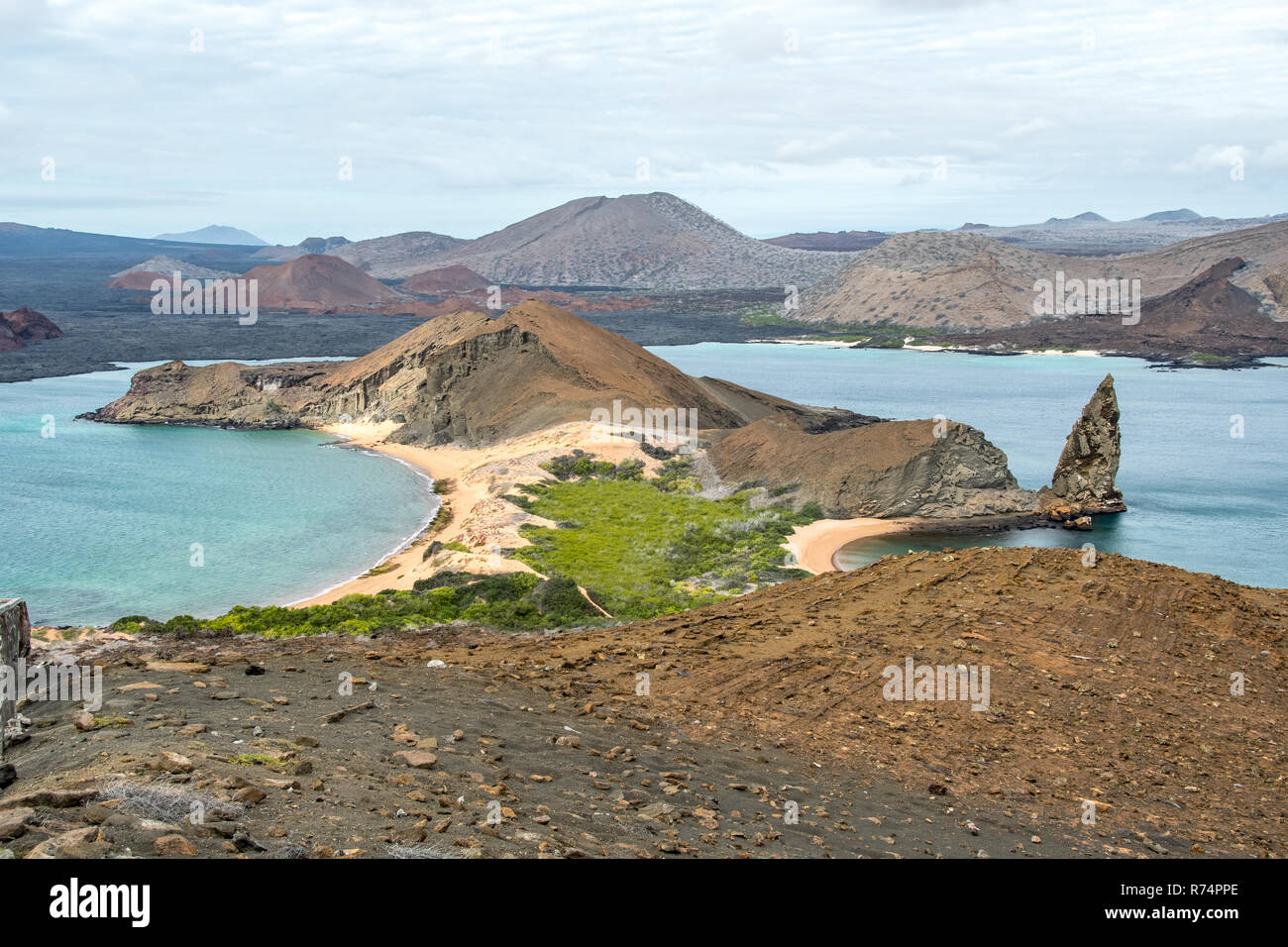 Panorama on the lava pinnacle and Santiago Island seen from the summit of Bartolome Island crater, Galapagos Islands Stock Photo