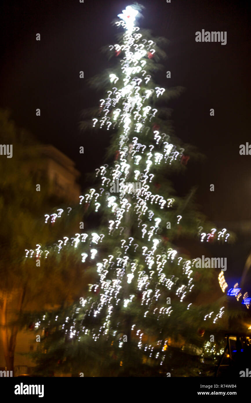 Defocused christmas tree lights. Question mark shaped bokeh Stock Photo