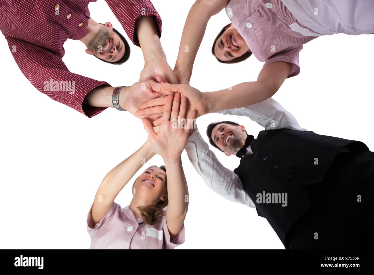 Hotel Staff Stacking Their Hands Stock Photo