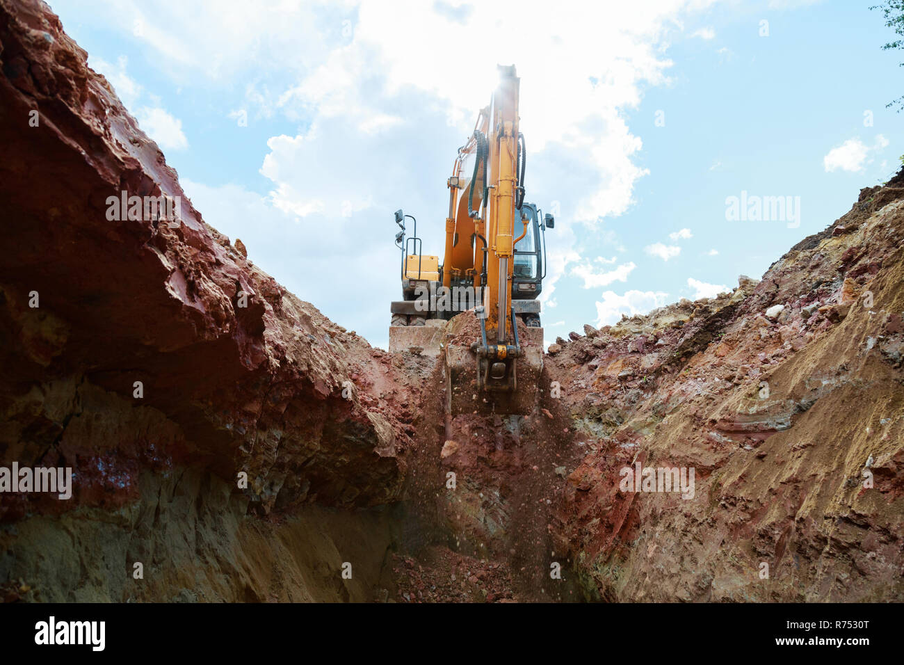 Excavator digging a trench for the pipeline. Excavation Stock Photo - Alamy