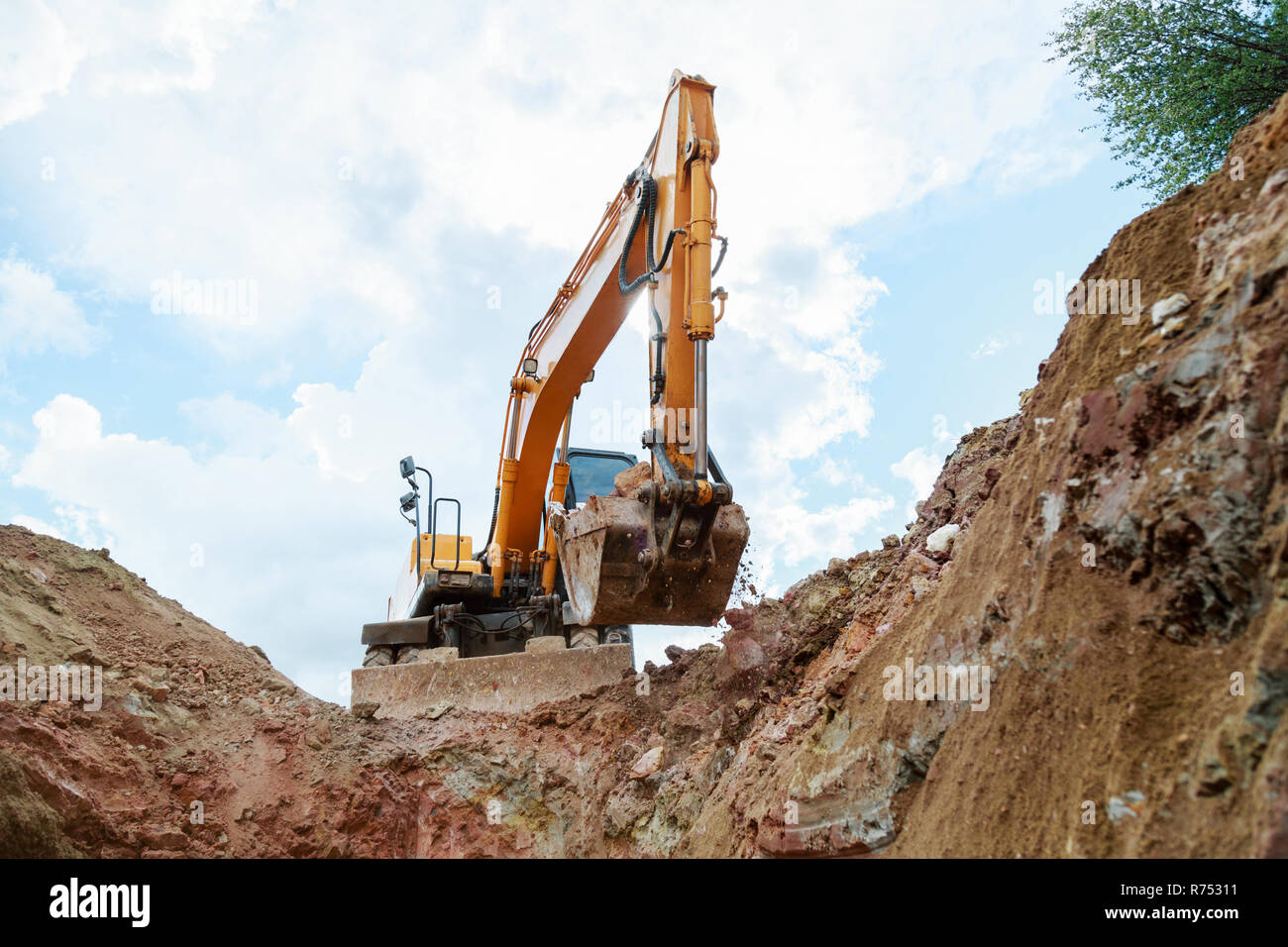 Excavator digging a trench for the pipeline. Excavation Stock Photo - Alamy