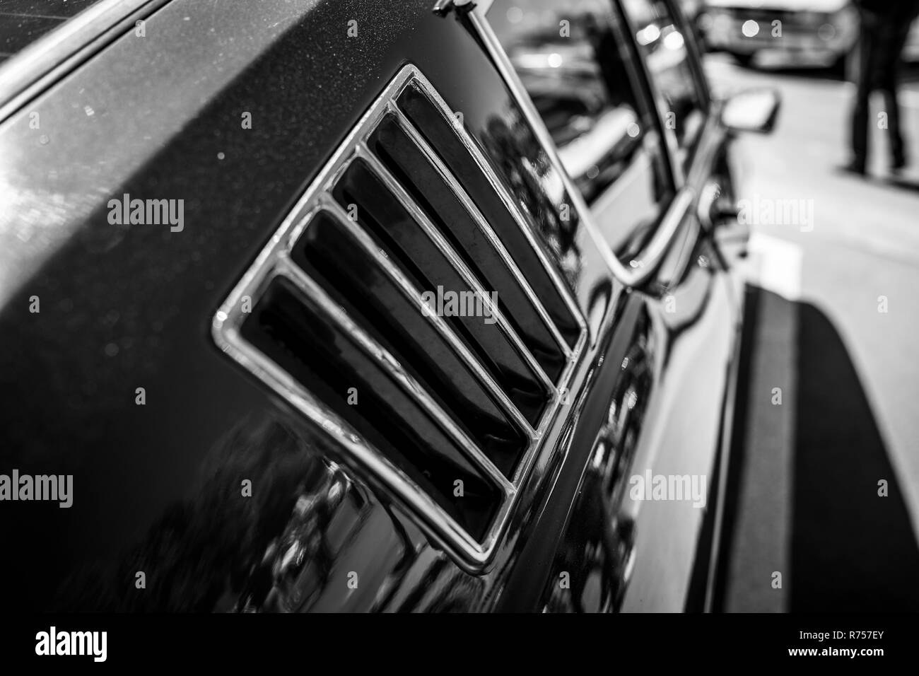 Ventilation grille in the body of a sports car. Black and white