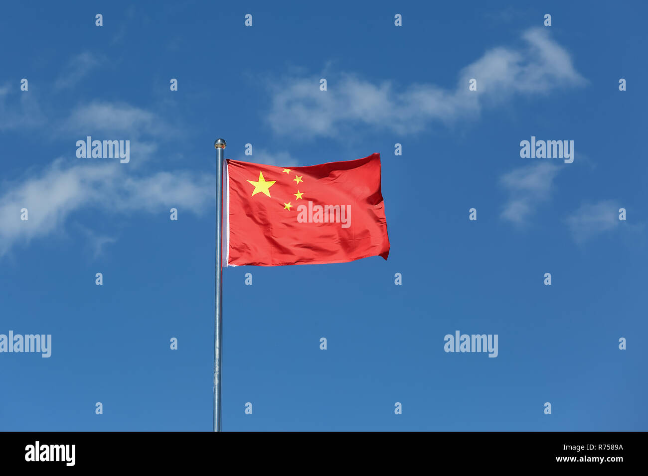 China Flag Waving in the wind on blue sky , . Stock Photo