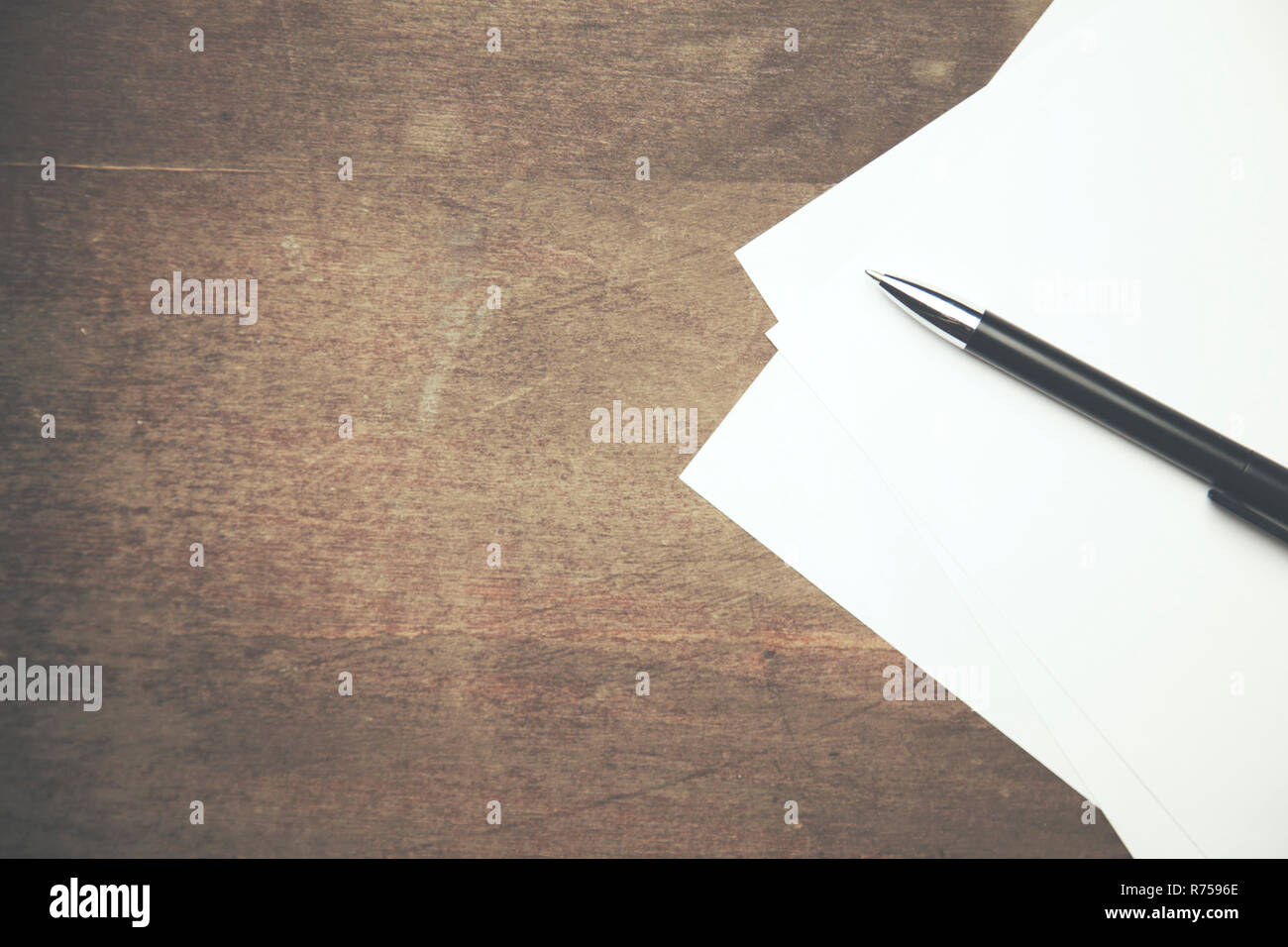 papers and pen on working wooden  table Stock Photo
