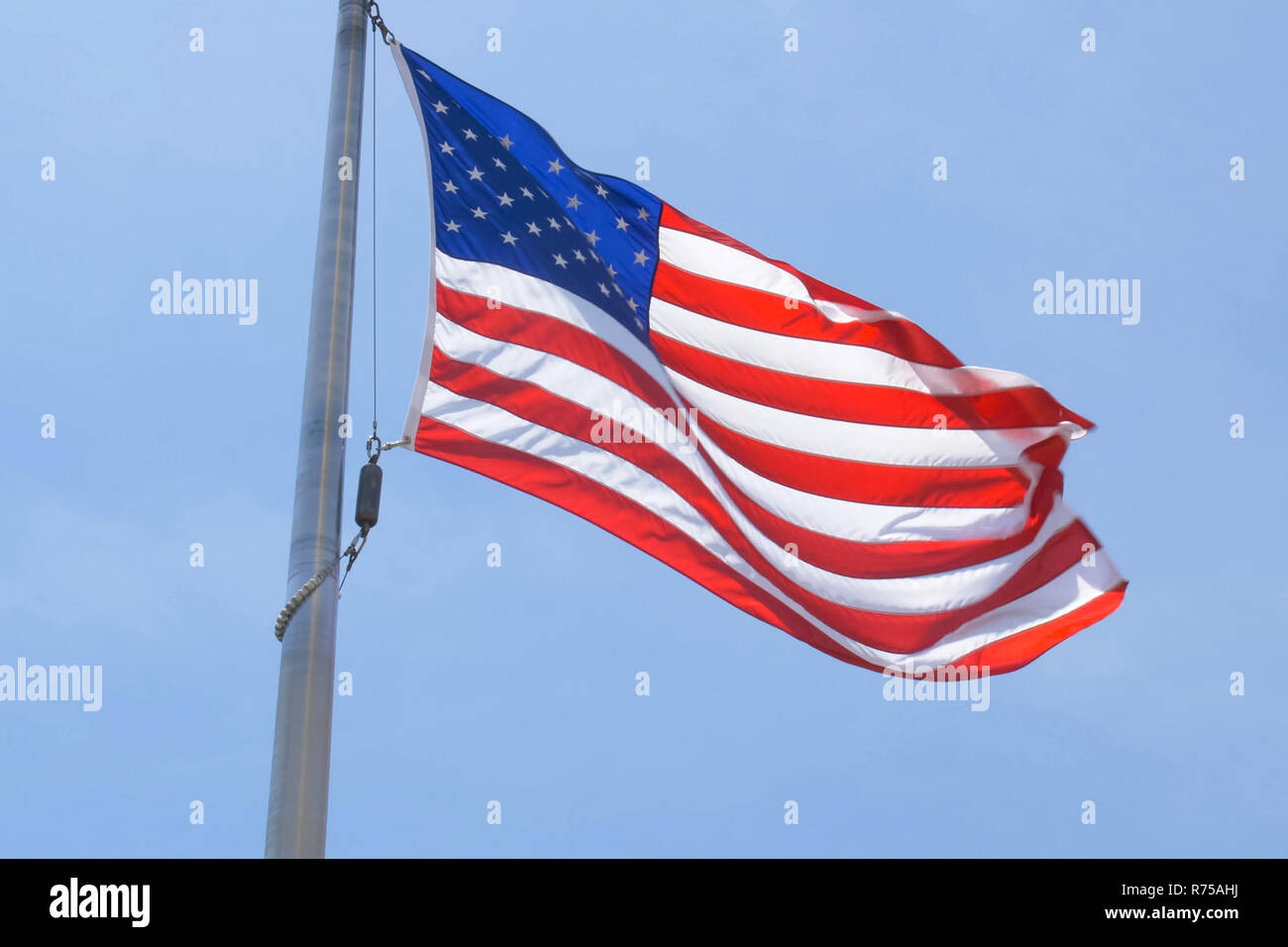 American flag on a pole. The flag flies by the wind Stock Photo - Alamy