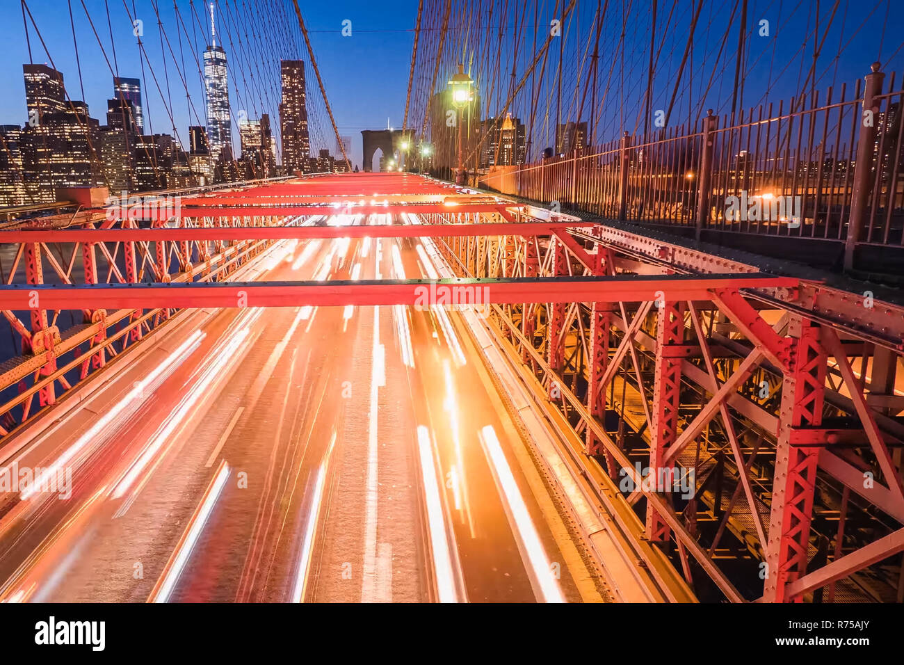 Night lights of car headlamps on the Brooklyn bridge. Long exposure Stock Photo