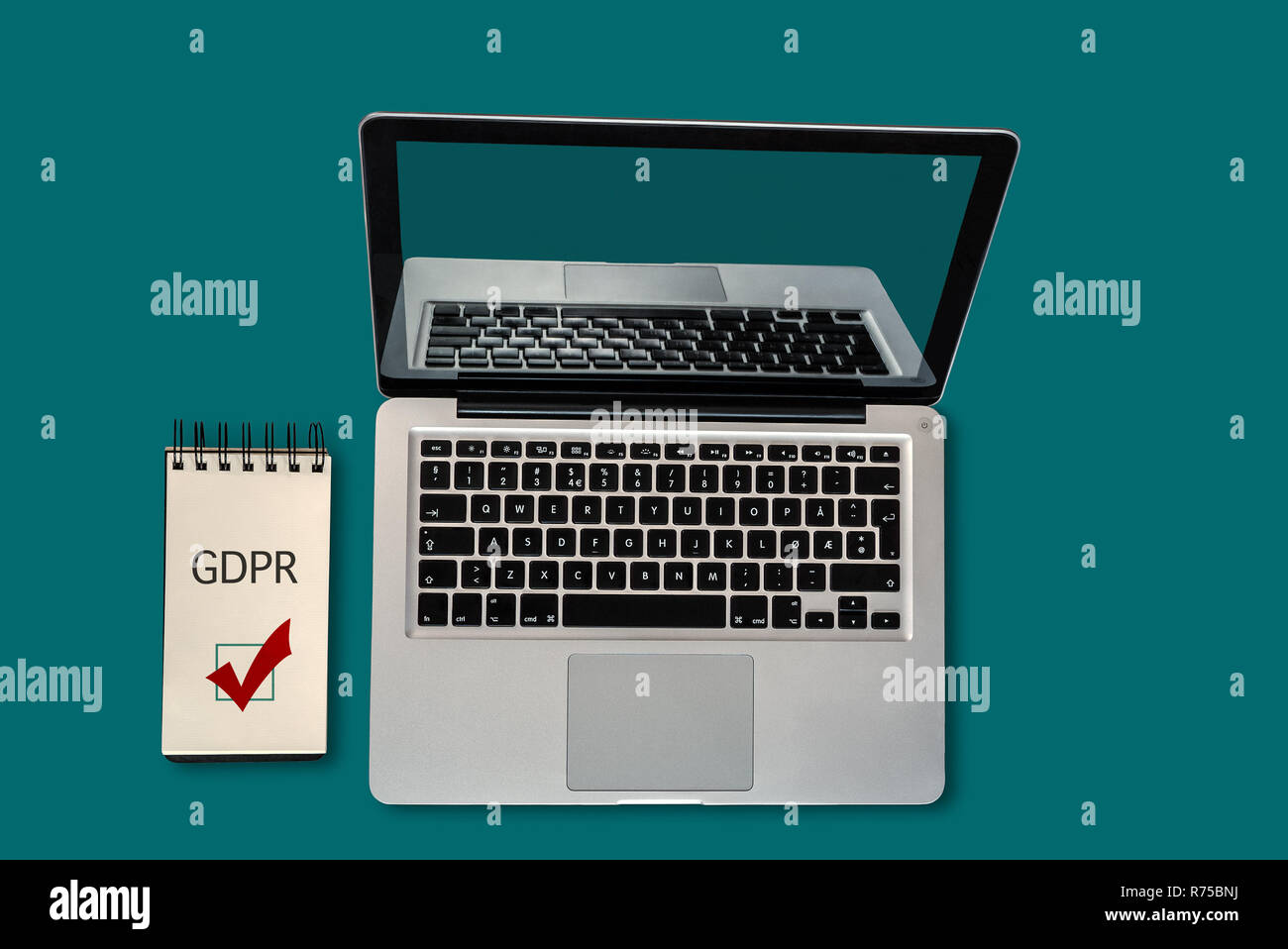 Top view of a laptop and a notepad with GDPR and a ticked checkbox on it, with copyspace Stock Photo