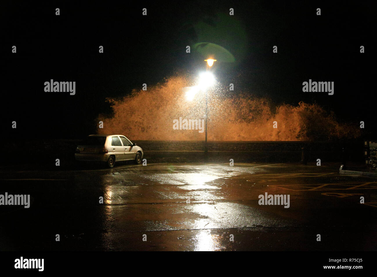 Very strong winds coincided with high tides in the North Devon coastal town of Ilfracombe this evening. Stock Photo
