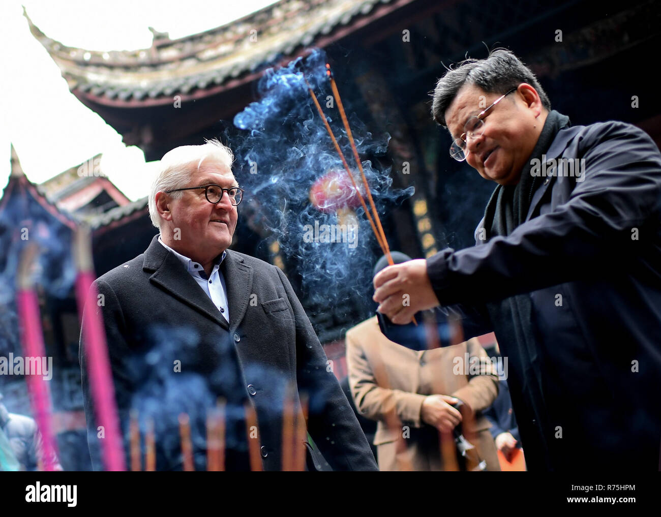 Dujiangyan, China. 08th Dec, 2018. Federal President Frank-Walter Steinmeier (l) and Lu Sheng, Party Secretary of the City of Dujiangyan, light incense sticks in Erwang Temple. President Steinmeier is on a state visit to Dujiangyan on the occasion of a six-day trip to China. Credit: Britta Pedersen/dpa-Zentralbild/dpa/Alamy Live News Stock Photo