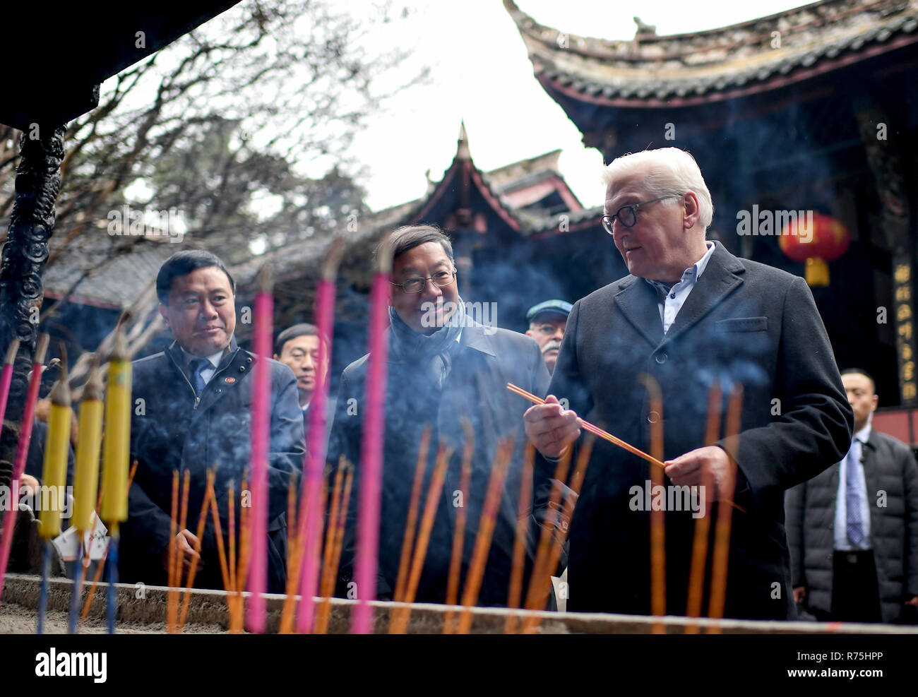 Dujiangyan, China. 08th Dec, 2018. Federal President Frank-Walter Steinmeier (r) and Shi Mingde (M), Ambassador of the People's Republic of China, light incense sticks in Erwang Temple. President Steinmeier is on a state visit to Dujiangyan on the occasion of a six-day trip to China. Credit: Britta Pedersen/dpa-Zentralbild/dpa/Alamy Live News Stock Photo