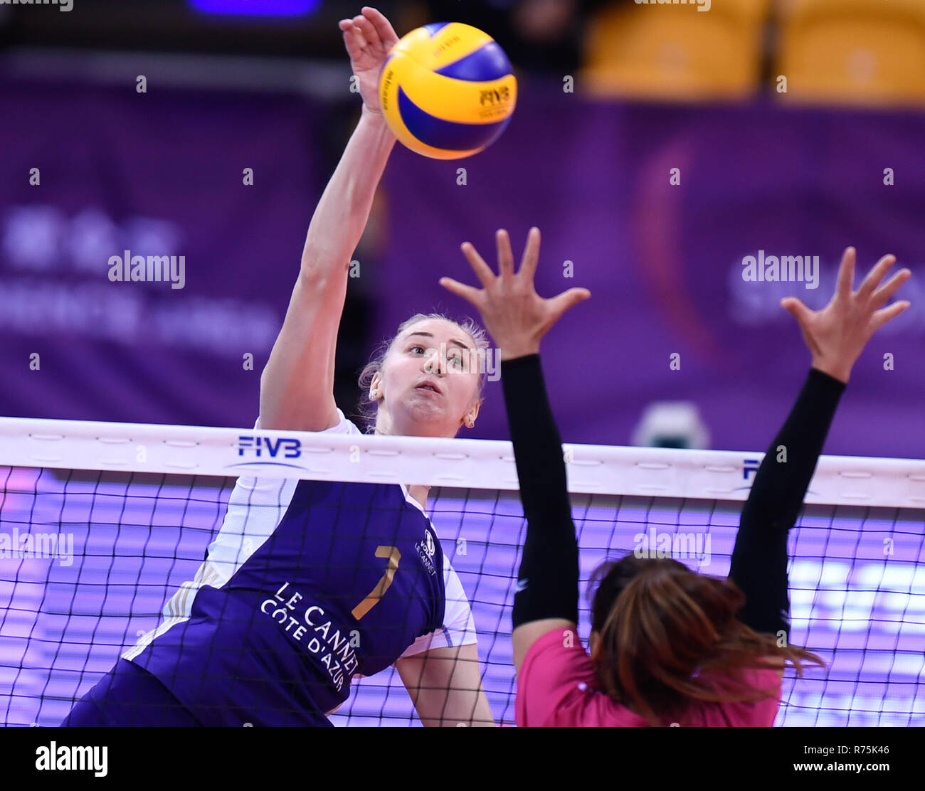Shaoxing, China's Zhejiang province. 8th Dec, 2018. Angelina Lazarenko (L)  of Volero Le Cannet spikes the ball during a Classification 5-8 match  between Supreme Chonburi of Thailand and Volero Le Cannet of