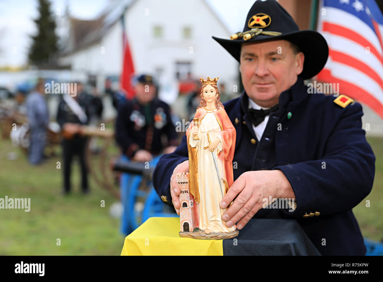 Magdeburg, Germany. 08th Dec, 2018. Firecracker Captain Mirko Bock sets up a figure of Saint Barbara, the patron saint of the cannoneers, at the Klutturm. The firecrackers are for a peaceful purpose, to honour the canonized Barbara von Nikomedien, who among other things is the patron saint of artillery, demolition master, gunner and gunsmith embodied and depicted with a cannon. Credit: Peter Gercke/dpa-Zentralbild/ZB/dpa/Alamy Live News Stock Photo