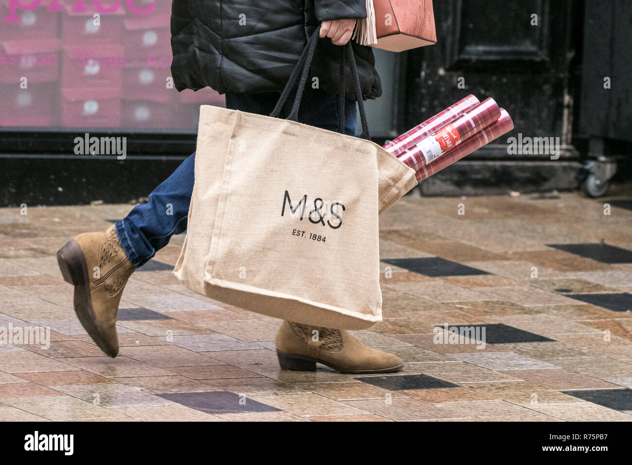Marks and Spencer shopping bag M&S Christmas Shopping.  Christmas shopping on the high streets of Blackpool in Lancashire.  With just over two weeks remaining till the festive period begins, savvy shoppers fill their bags with the latest must haves for family and friends. Stock Photo