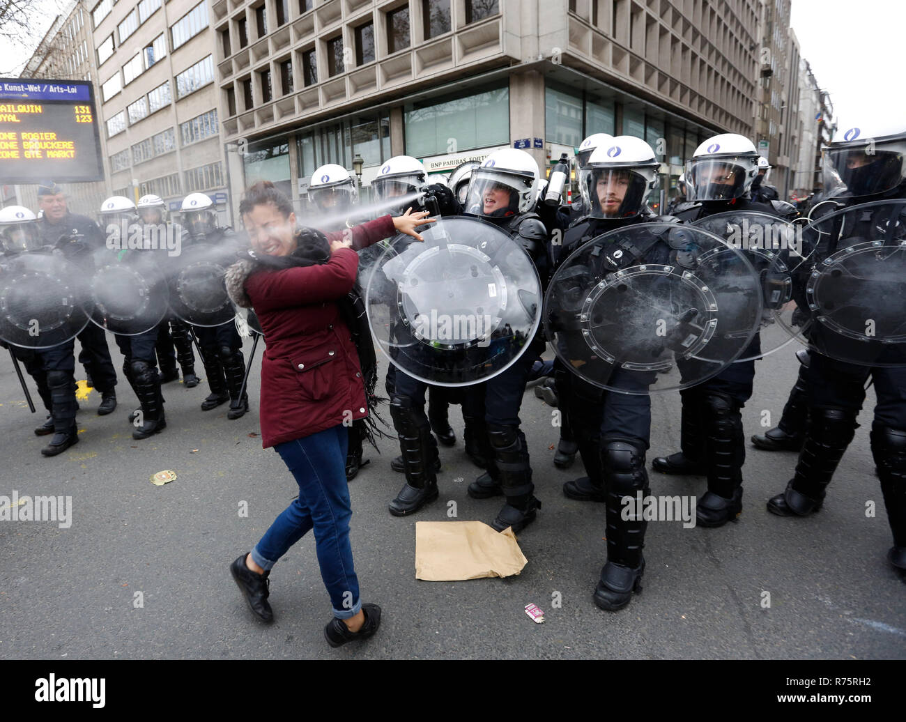 Brussels, Belgium. 8th Dec, 2018. A Police officer squirts pepper water to a protester of the 'yellow vests' during a demonstration in downtown Brussels, Belgium, Dec. 8, 2018. Credit: Ye Pingfan/Xinhua/Alamy Live News Stock Photo