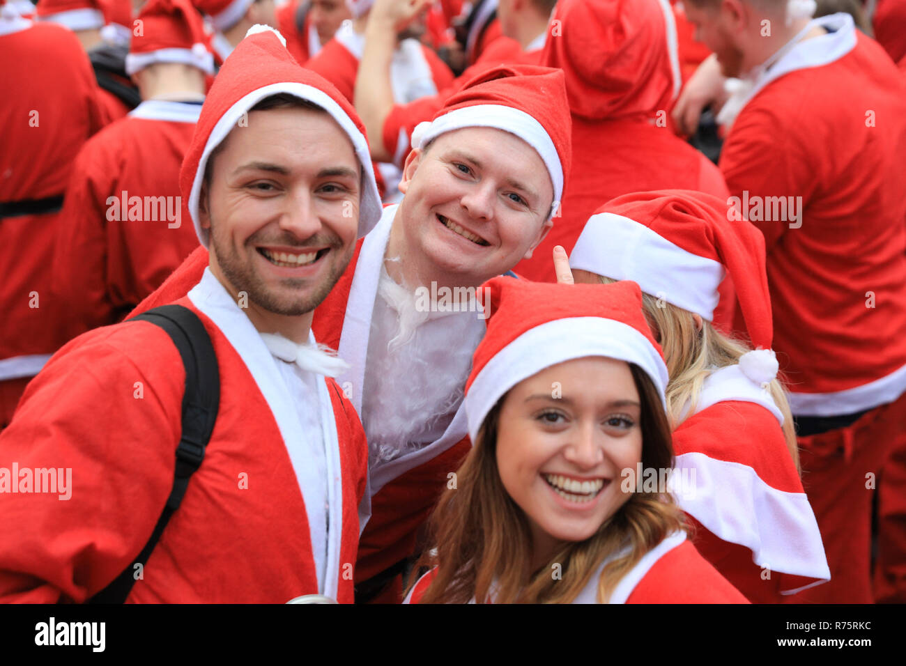 London, UK, 8th Dec 2018. Santa and his helpers having fun around Euston Station and Bloomsbury Square. The annual London Santacon once again sees thousands of participants in Santa costumes assemble at different places in London, then setting off on different routes around the landmarks of the capital before eventually convening in the centre of London. This year, Santacon supports London based charity Christmas for Kids. Credit: Imageplotter News and Sports/Alamy Live News Stock Photo