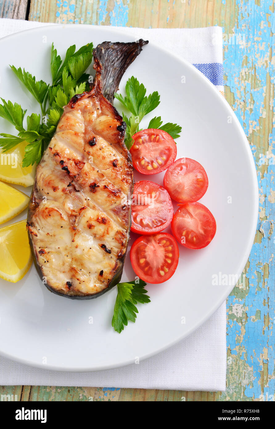 Fish grill on white plate Stock Photo - Alamy