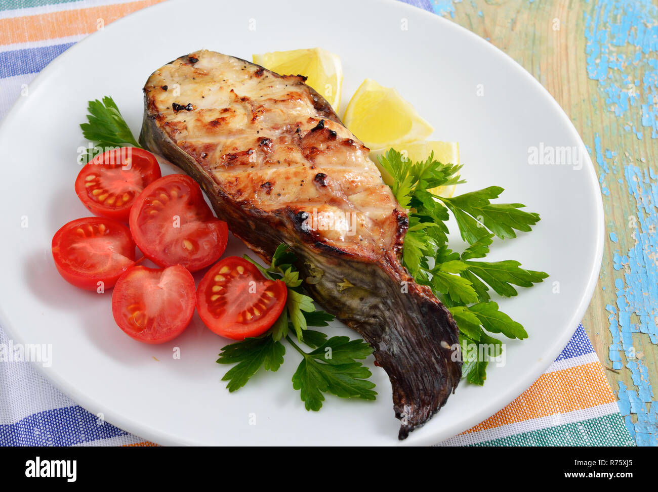 Fish grill on white plate Stock Photo - Alamy