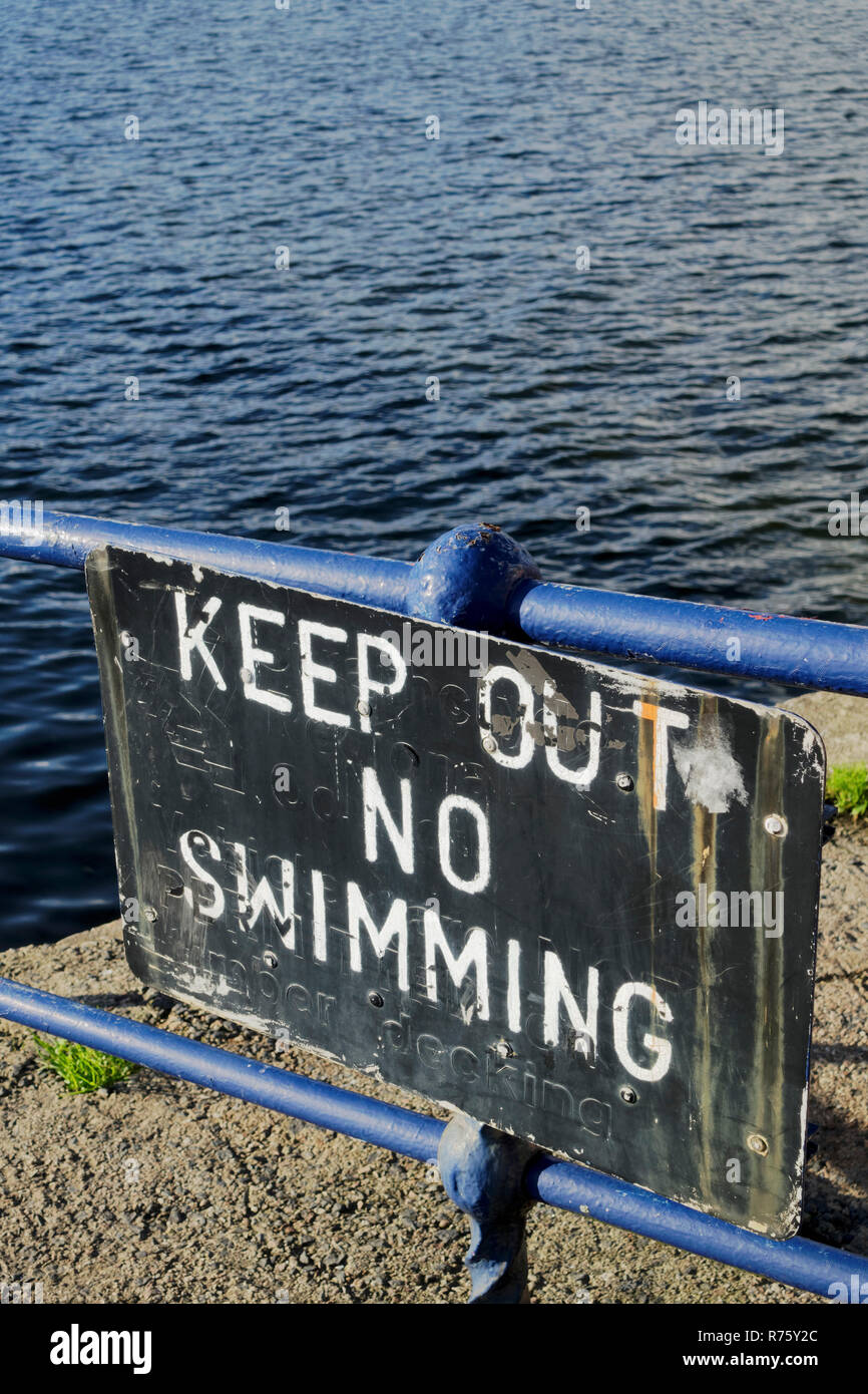 Keep out no swimming sign on pier at Rothesay, Isle of Bute, Scotland. Stock Photo
