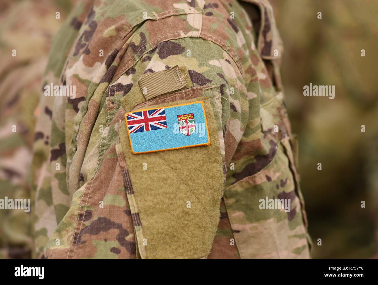 Flag of Fiji on soldiers arm. Flag of Fiji on military uniforms (collage). Stock Photo