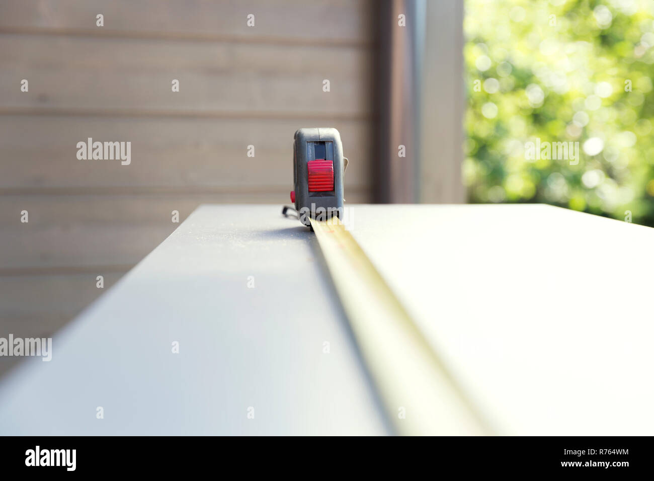 Furniture assembly. Construction measuring tape on chipboard furniture