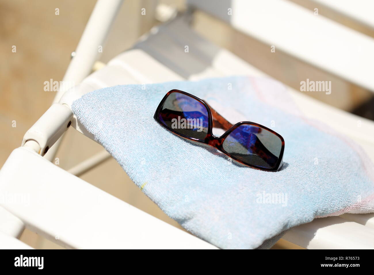 sunglasses on bath towel Stock Photo