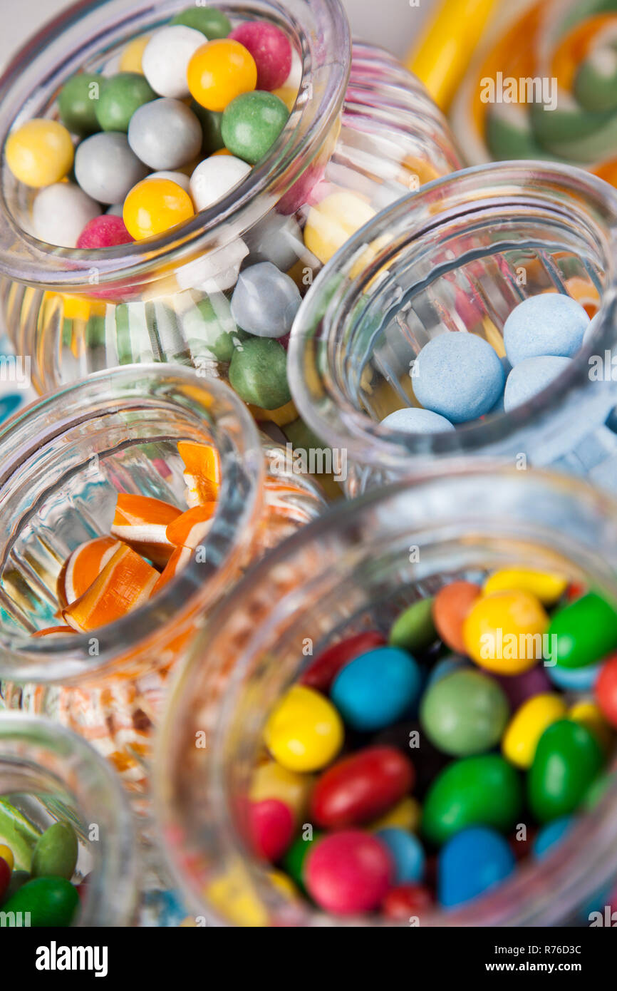 Colorful lollipops and different colored round candy and gum balls ...