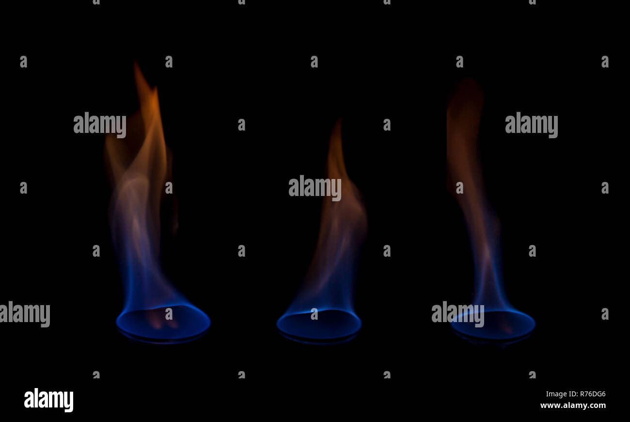 Blue and yellow colored flames isolated on black background Stock Photo