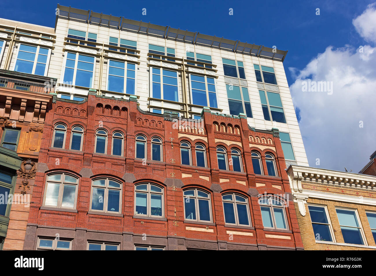 Washington DC buildings, coexistence of different styles in urban architecture. Beautiful buildings under a blue sky with cumulus clouds in US capital Stock Photo