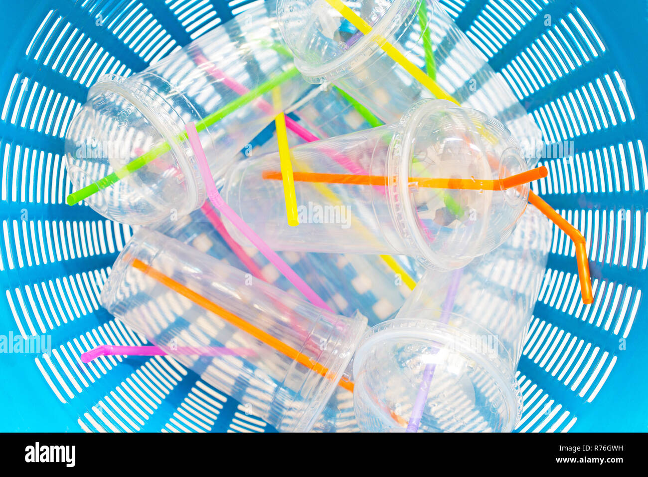 Plastic cups with straws in waste basket. Stock Photo
