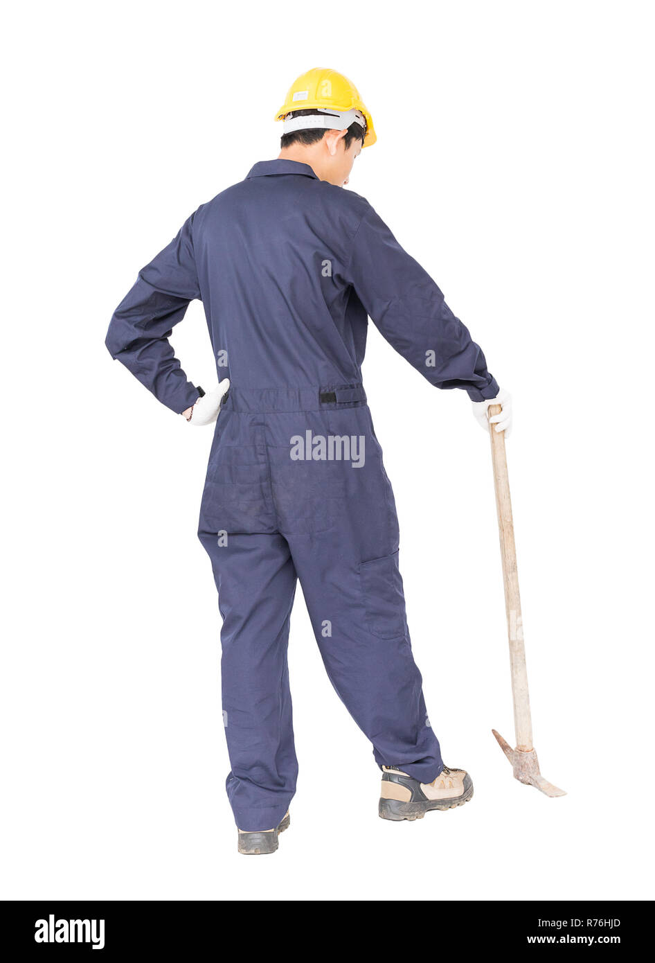 Man in uniform hold old pick mattock that is a mining device Stock Photo