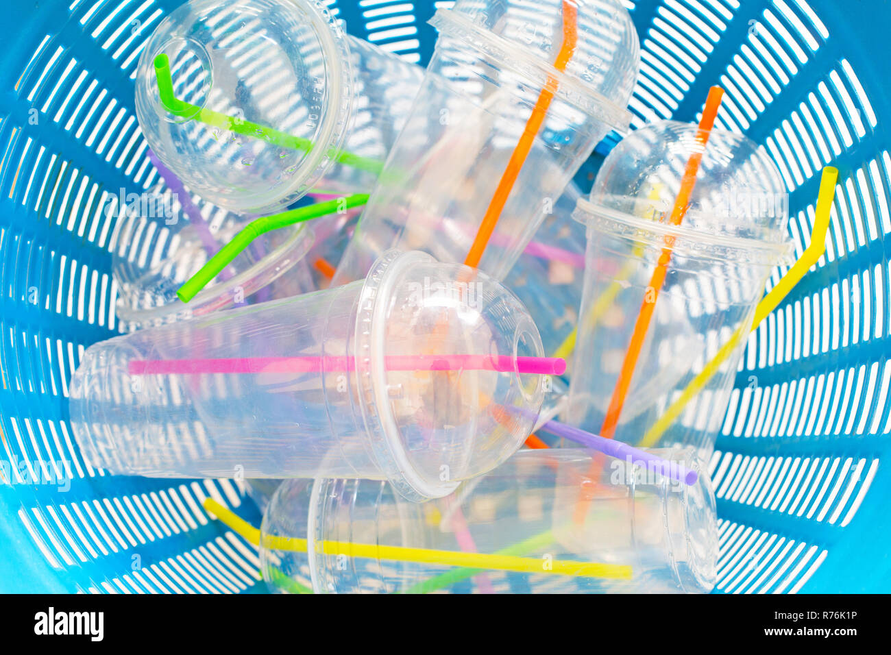 Plastic cups with straws in waste basket. Stock Photo