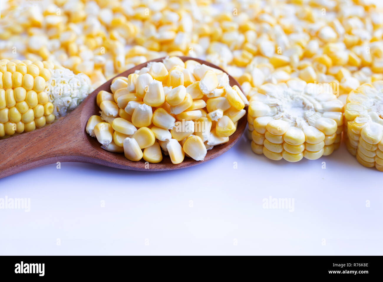 Corn seeds and ripe corn cobs on  white background. Stock Photo