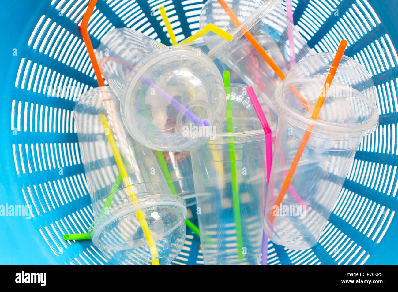 Plastic cups with straws in waste basket. Stock Photo