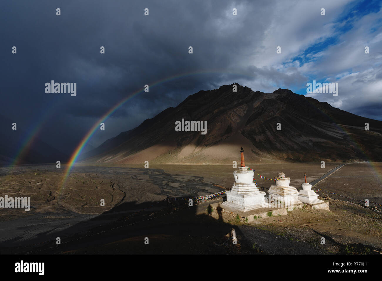 Double rainbows and overcast rainy sky and pagodas in Zanskar valley, India Stock Photo