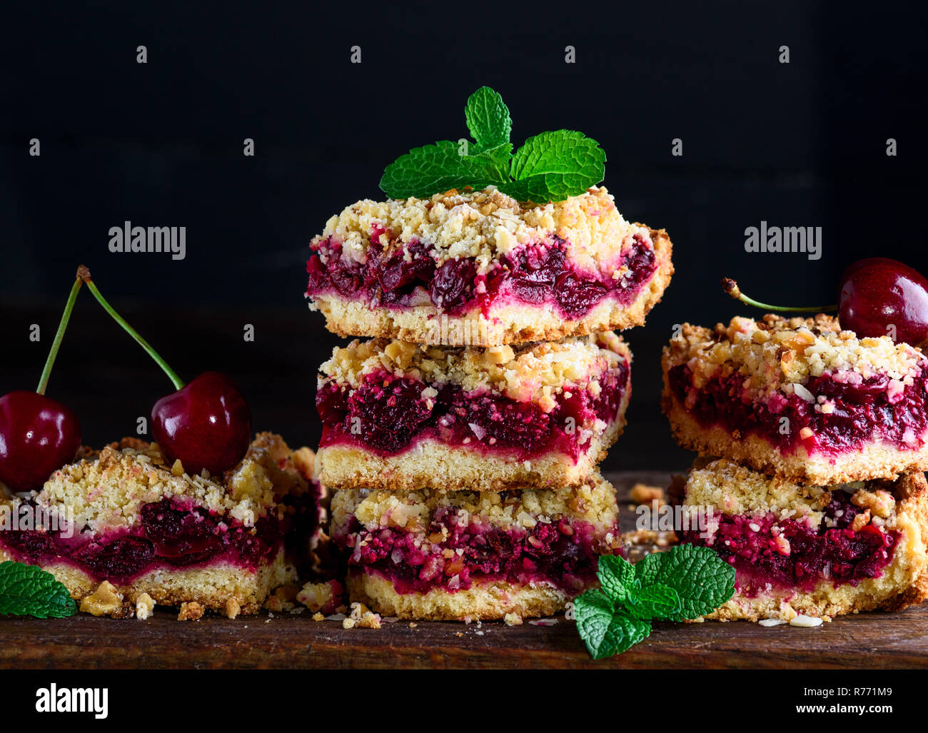stack of square slices of a pie with a cherry Stock Photo