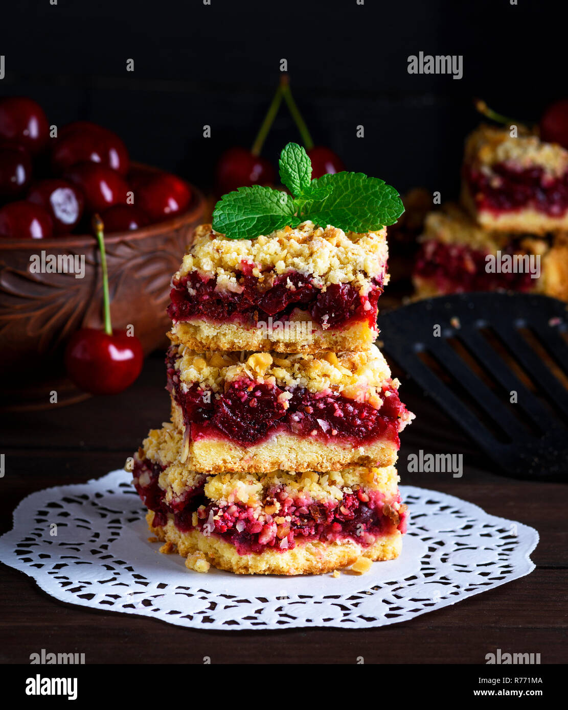 a pile of square pieces of a pie with a cherry Stock Photo