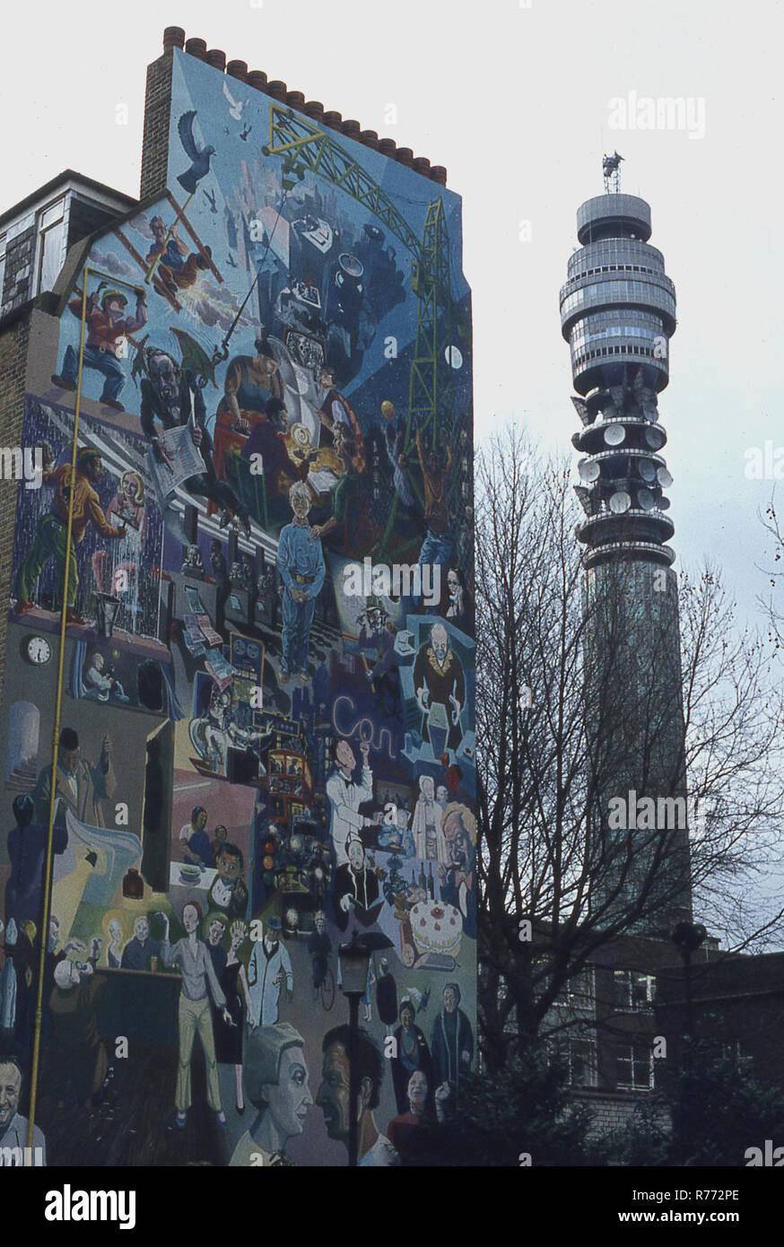 1970s, historical, a wall of a tall building with graffiti artwork on, seen next to the communication tower, the Post Office tower, London, England, UK. The tower was the tallest buidling in the UK from 1964 to 1980. Stock Photo