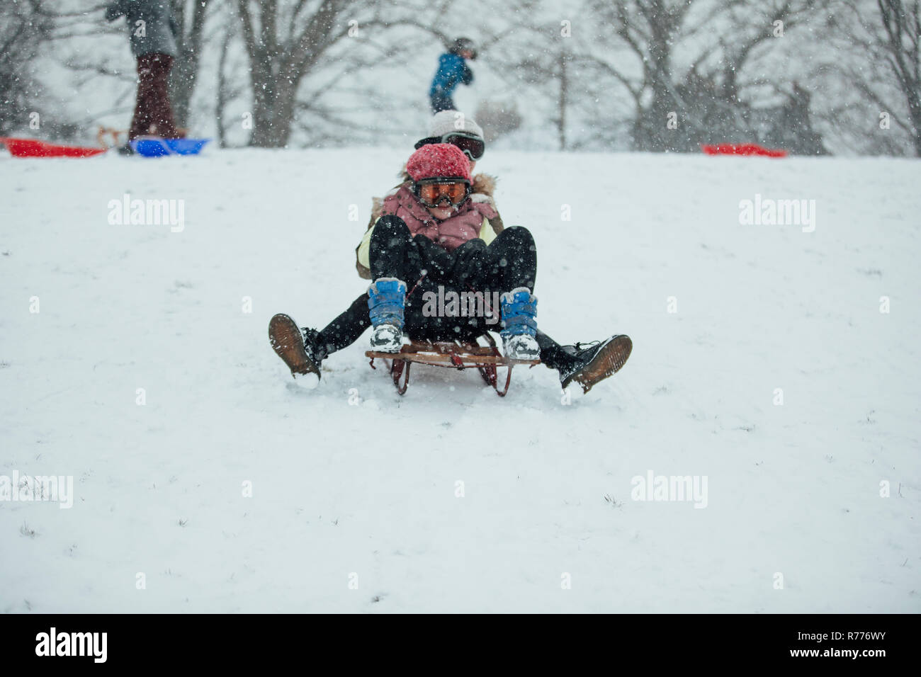 Sledding Down the Hill Stock Photo Alamy