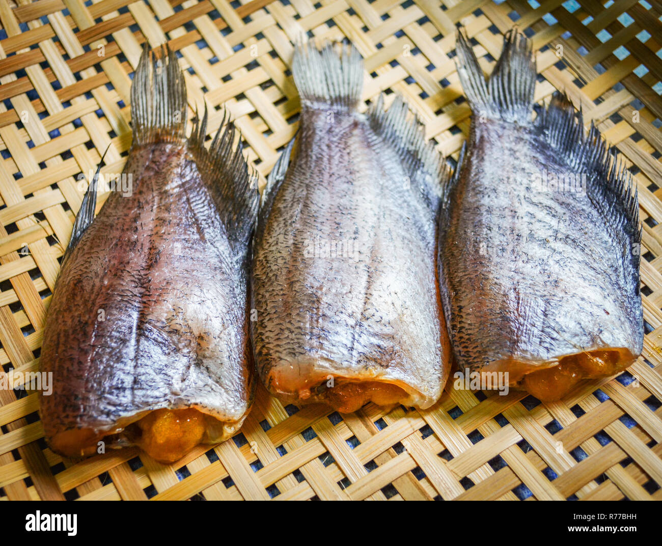 sun dried fish / trichogaster pectoralis fish dried with spawn on bamboo basket Stock Photo