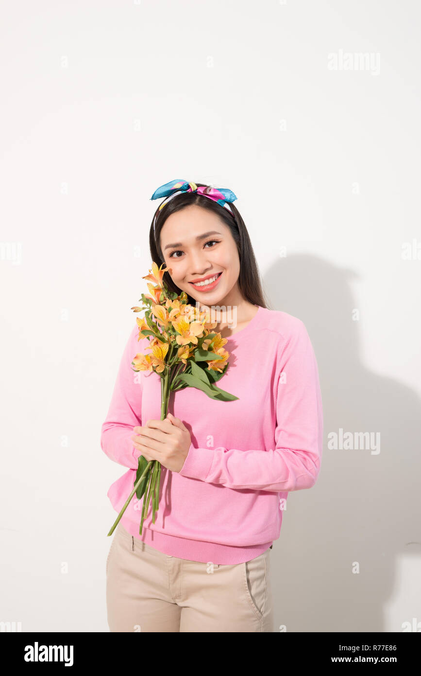 Lifestyle leisure international women's day concept. Close up portrait of lovely cute adorable excited delightful attractive woman holding flowers iso Stock Photo