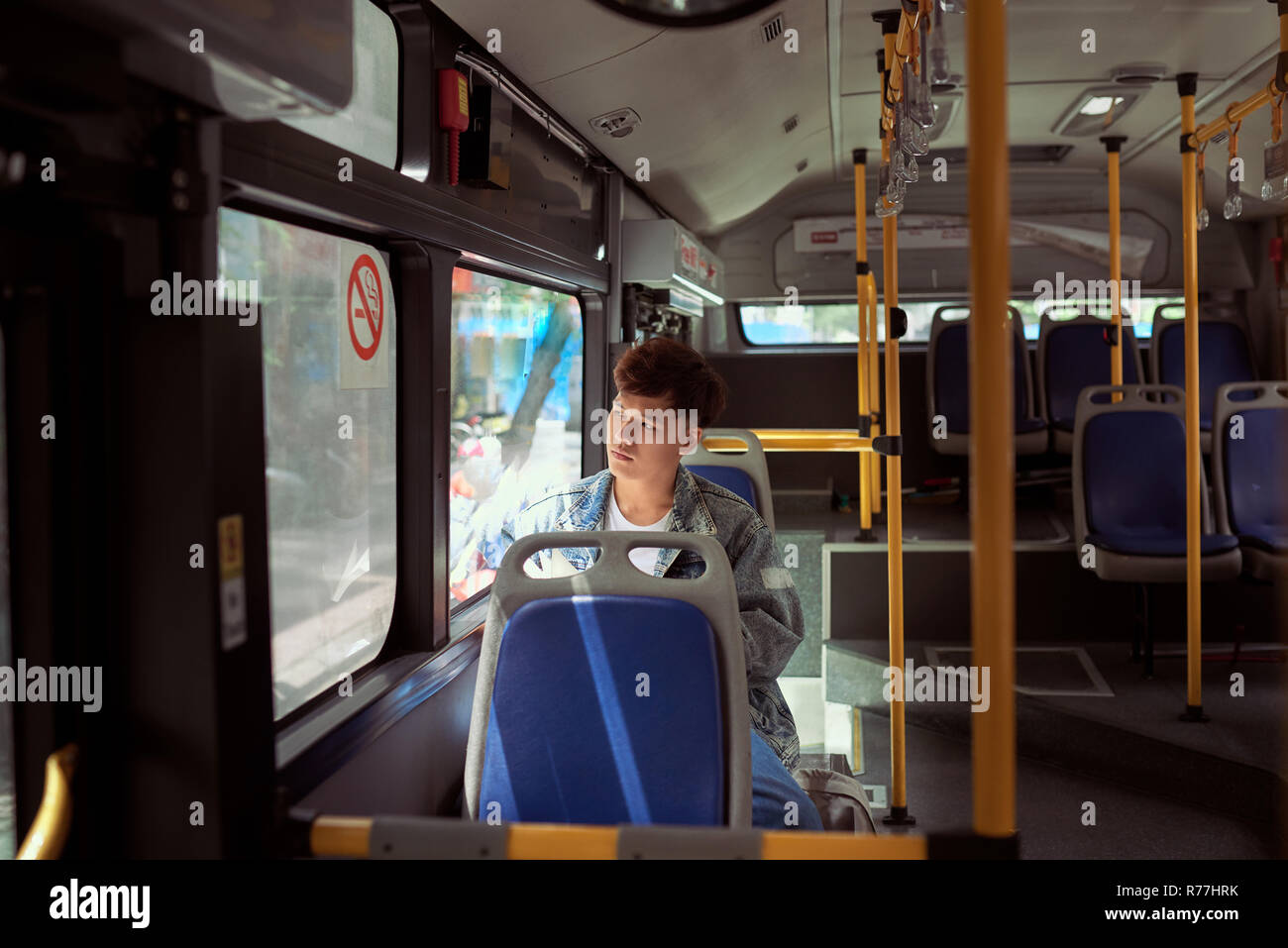 passenger traveler looking at window in bus, man tourist sitting in bus Stock Photo
