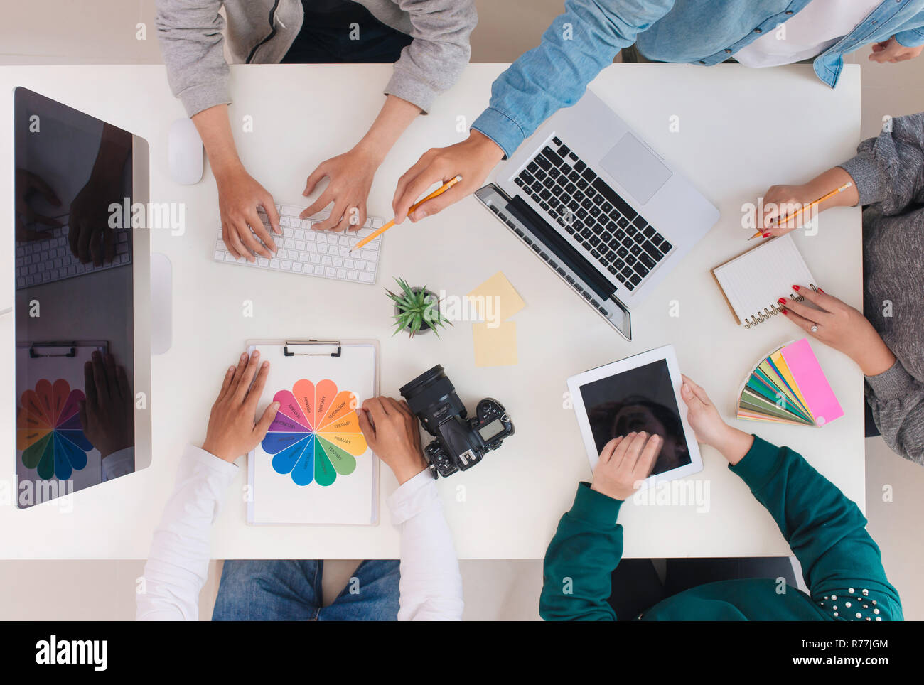 Young creative team having a meeting in creative office - teamwork concepts. Stock Photo