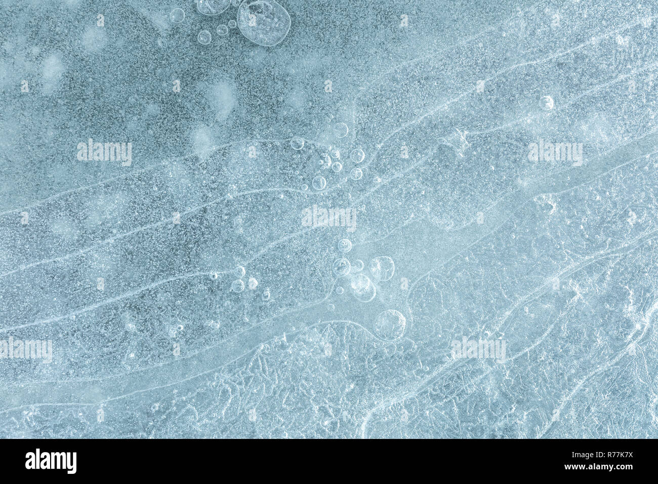 Cracked surface patterns of frozen water surface. Natural winter texture Stock Photo
