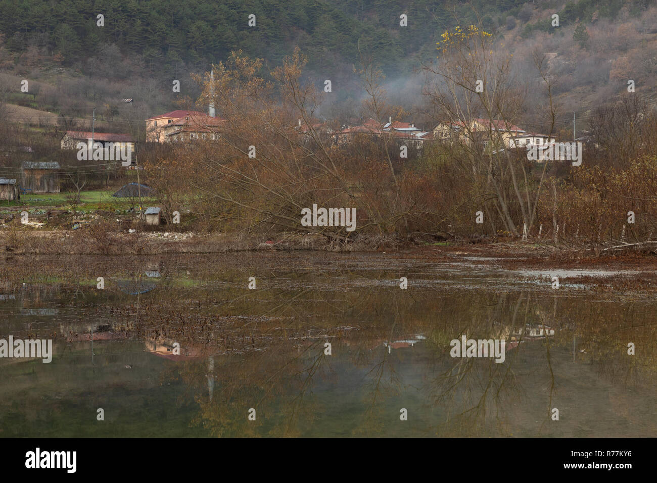 reflection of Çubuklu village in the calm water of Çubuklu lake in the Bolu mountains of Turkey Stock Photo