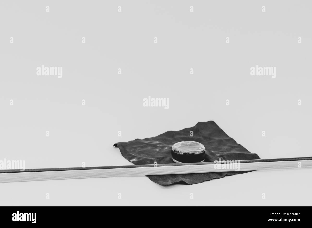 violin rosin and bow on a black cloth - white background Stock Photo
