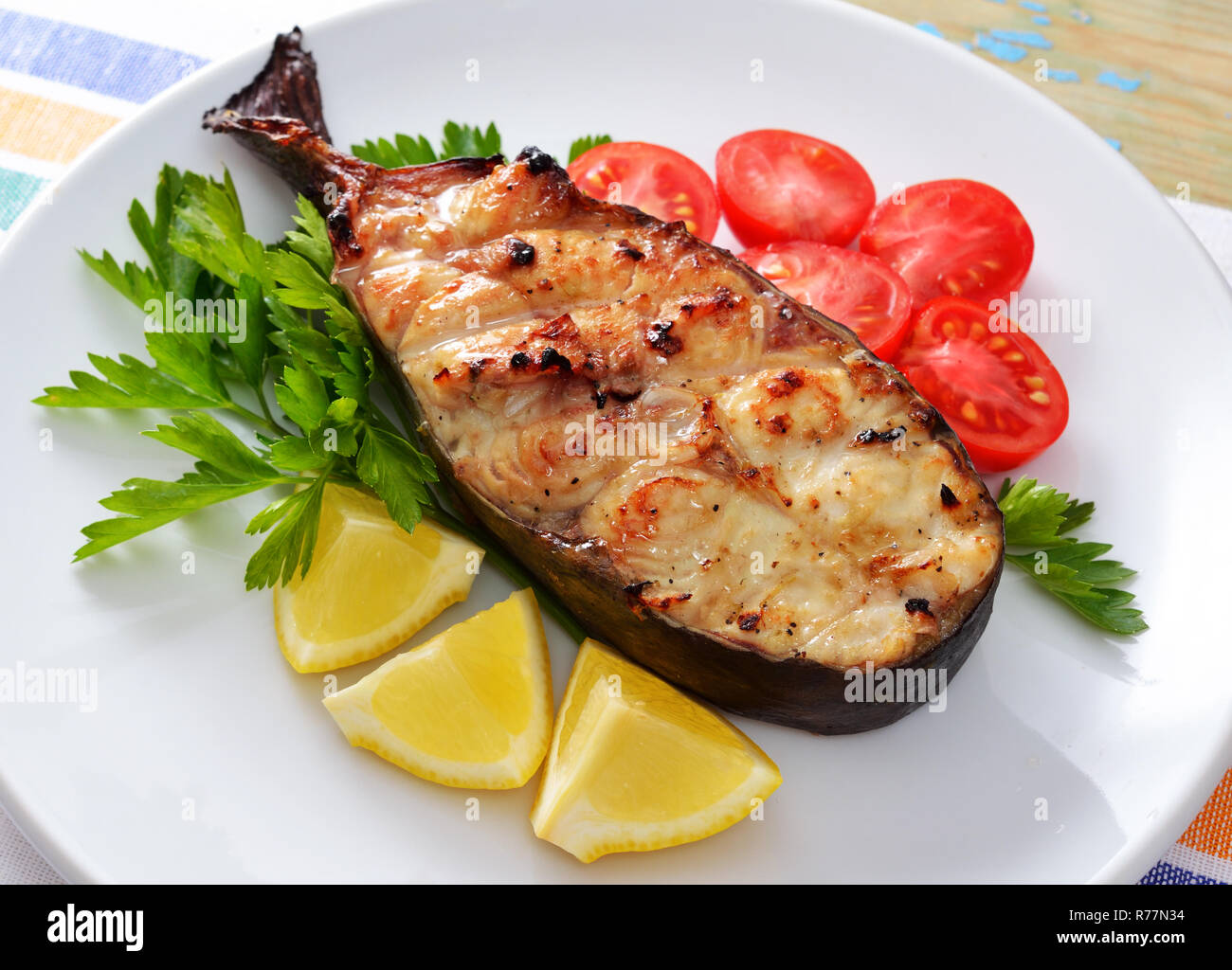 Fish grill on white plate Stock Photo - Alamy
